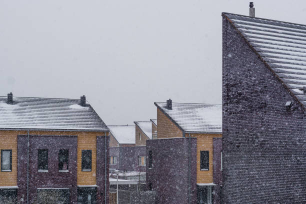 istock modern house rooftops covered in snow during snowy weather, Modern dutch architecture background 1124719330