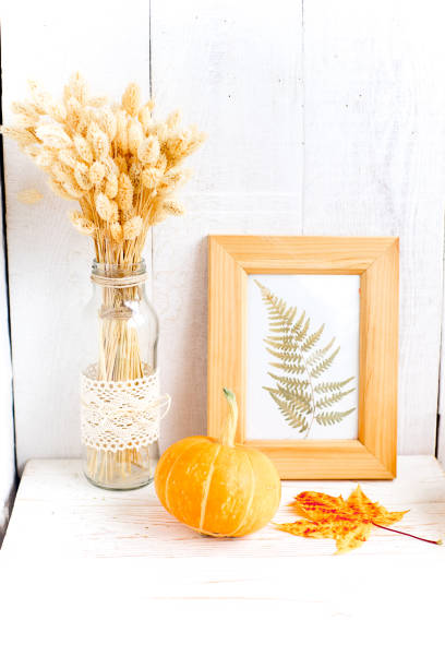 istock Autumn composition with dry leaves and ripe pumpkins 1124719886