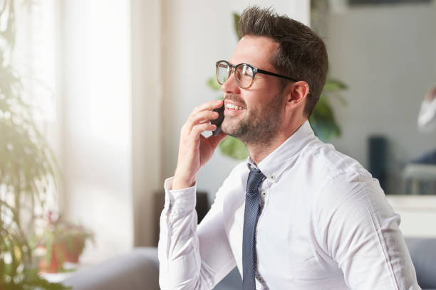 istock Businessman making a call while sitting in the office 1124723878