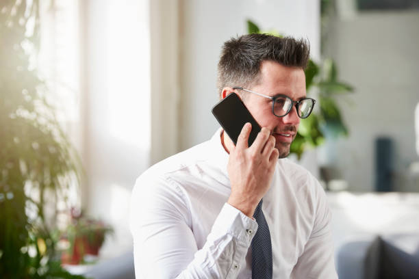istock Businessman making a call while sitting in the office 1124723891