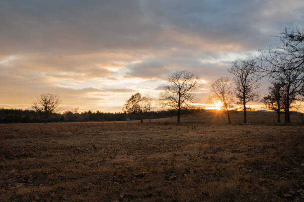 Beautiful golden  Sunset on a Ranch in Oklahoma sky filled with clouds