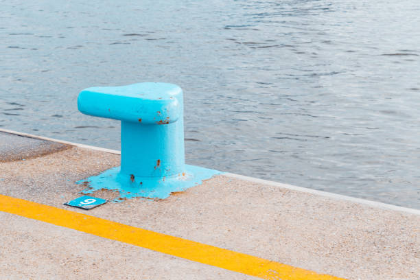 A blue bollard on a concrete quay in the harbor