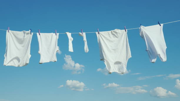 istock White linen dries on a rope against a clean blue sky 1124730645