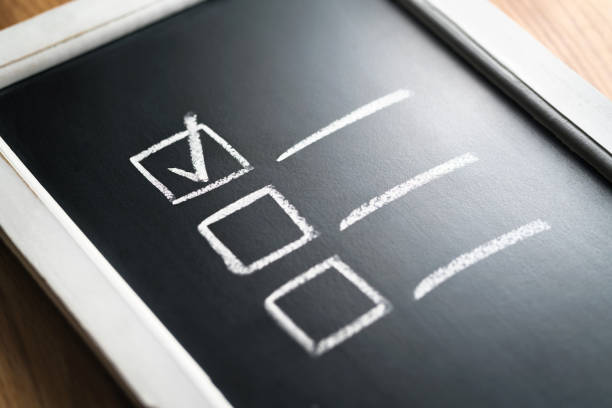 istock Checklist on chalkboard. Agenda and progress of project in business. Document of finished work duties and responsibilities. Checklist of completed tasks and keeping score. 1124733041