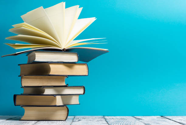 istock Open book, hardback books on wooden table. Back to school. Copy space 1124733342