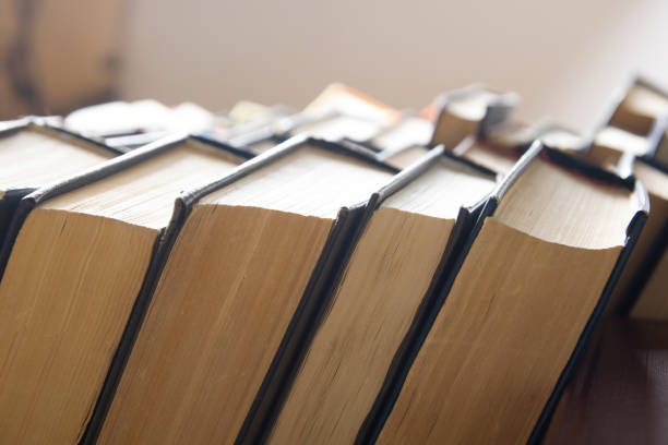 istock Open book, hardback books on wooden table. Back to school. Copy space 1124733519