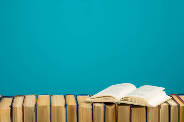 istock Open book, hardback books on wooden table. Back to school. Copy space 1124733699