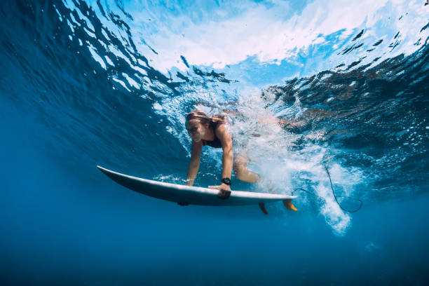 istock Attractive surfer woman dive underwater. Surfgirl under wave. 1124734366