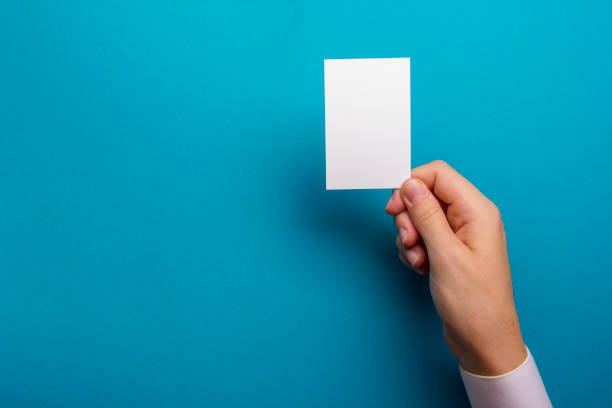istock Hand holding white business card on white background 1124734798