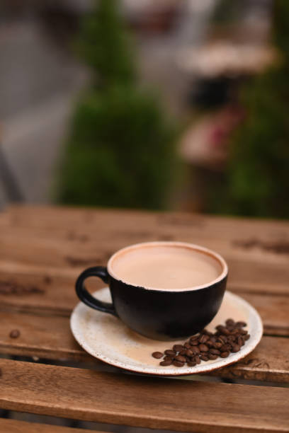 istock Cup of coffee with coffee beans on a wooden table 1124736746