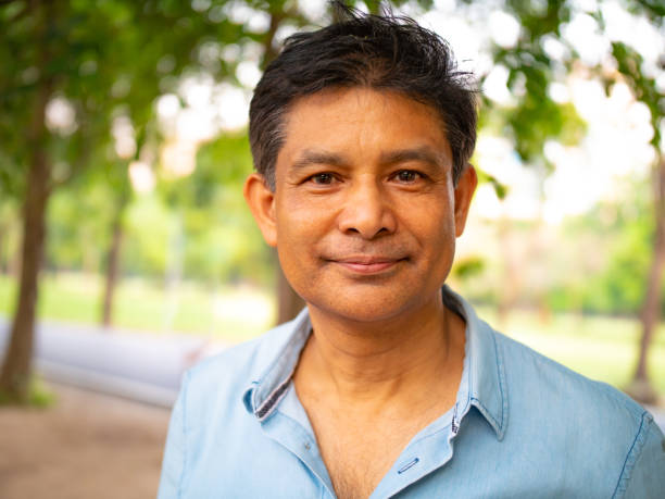 istock Portrait of a middle aged man in a park. 1124739077