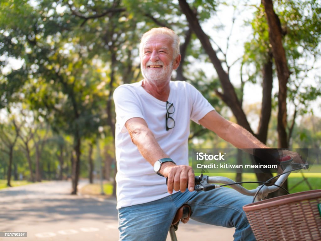 Portrait, Senior man on cycle ride in the park Senior Men Stock Photo