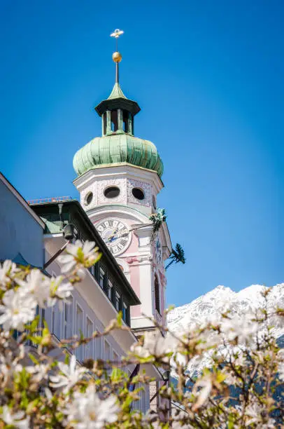 Innsbruck clock tower and the snowy Alps.