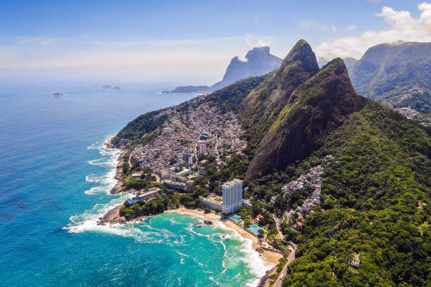 Rio de Janeiro, Brazil, Aerial View of Two Brothers Mountain and Favela Vidigal Rio de Janeiro, Brazil, aerial view of Two Brothers mountain (Morro Dois Irmaos) and Favela Vidigal in the summer, daytime. two brothers mountain stock pictures, royalty-free photos & images