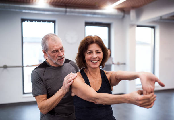 istock A senior woman in gym doing exercise with a personal trainer. 1124741552
