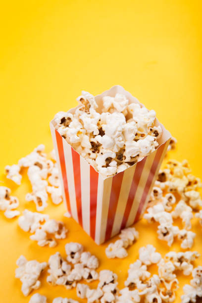 istock Classic box cinema popcorn on yellow background 1124741895