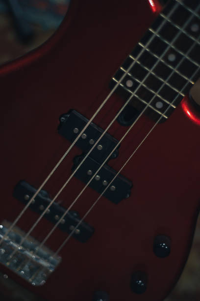istock Red bass guitar on a home musical studio background. 1124742564