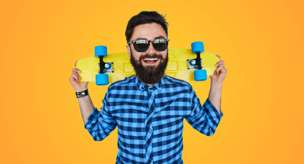 istock Hipster bearded man with a yellow skateboard 1124742831