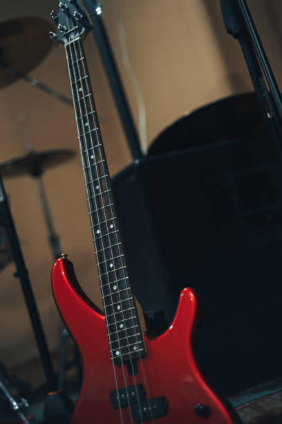 istock Red bass guitar on a home musical studio background. 1124742874