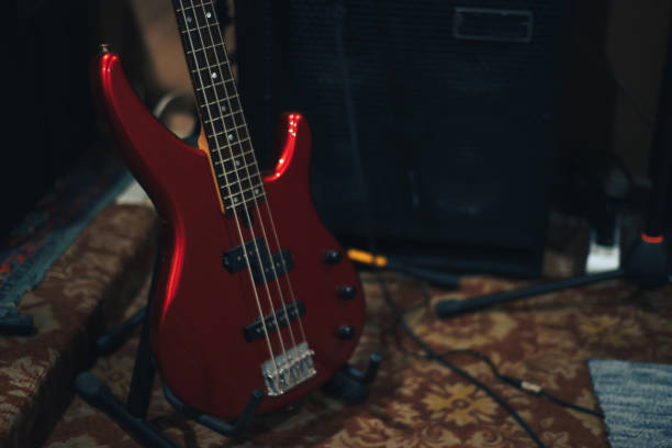 istock Red bass guitar on a home musical studio background. 1124742953