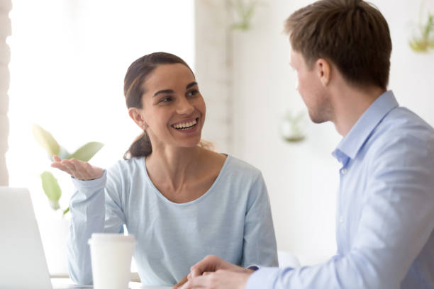 istock Smiling woman talking with colleague during break at workplace 1124743190