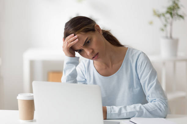 istock Frustrated woman using laptop, worried about problem, reading bad news 1124743220