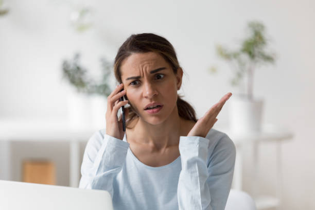 istock Upset unpleasantly surprised woman making phone call 1124743234