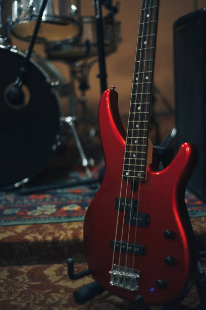 istock Red bass guitar on a home musical studio background. 1124744498