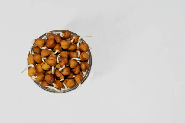 istock Black chickpeas or bengal gram sprouts on a bowl with white isolated background and high angle view,copy space. 1124744572