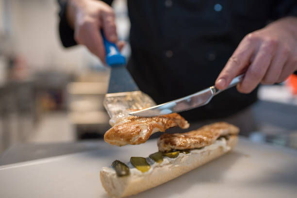 istock The Chef prepares a sandwich with grilled chicken. 1124744724