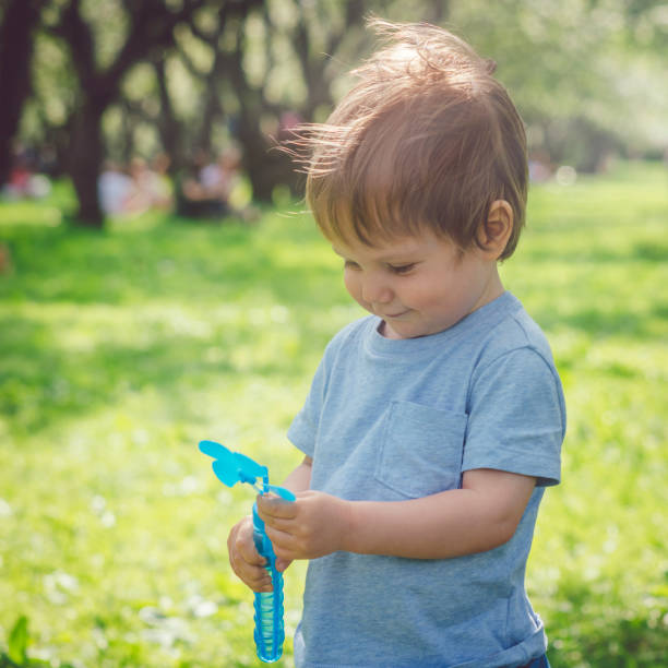 istock Cute boy having fun outdoors in summer park 1124746983