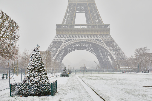 Scenic view to the Eiffel tower on a day with heavy snow. Unusual weather conditions in Paris