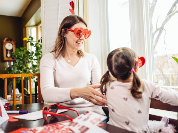 istock Mother and young daughter crafting for Valentine's Day 1124747810