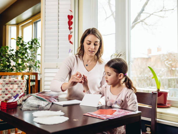 istock Mother and young daughter crafting for Valentine's Day 1124747896