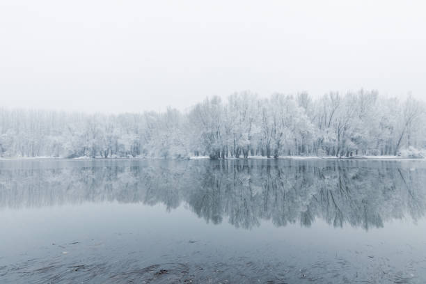 istock Winter lake scene reflecting in the water 1124748301