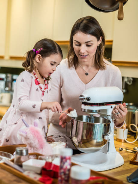 istock Mother and young daughter baking for Valentine's Day 1124749164