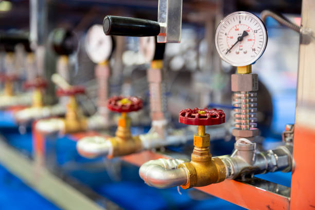 Pressure measuring instrument Pressure measuring instrument - bar, psi. Red metal valves on the pipes. Pressure device for industry system. gauge pressure gauge pipe valve stock pictures, royalty-free photos & images
