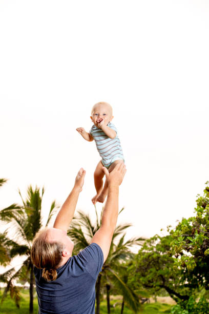 istock Father Tossing and Catching Son 1124749468