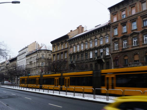 istock Budapest on a winter day under grey sky with blurry yellow tram speeding by 1124749653