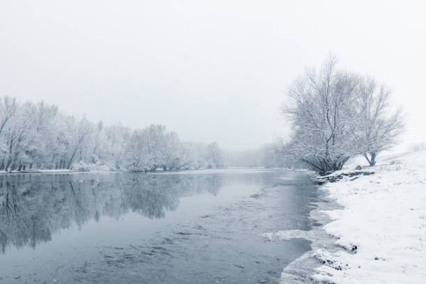 istock Winter lake scene reflecting in the water 1124750406