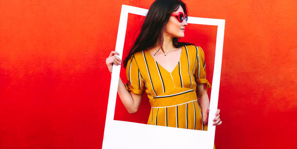 istock Pretty woman with a empty picture frame 1124752942