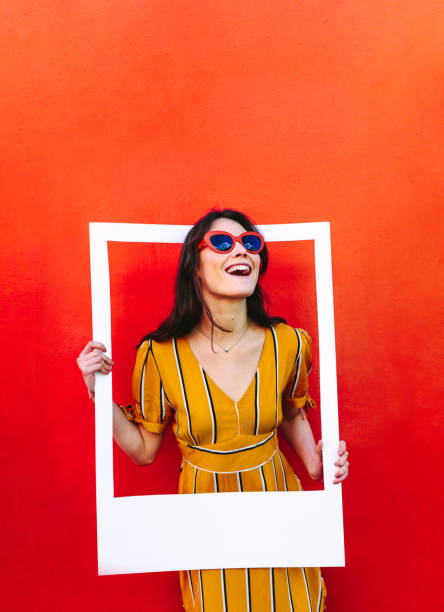 istock Stylish woman with large photo frame 1124753067