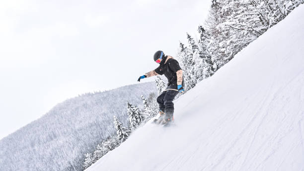 istock Snowboarder slides at ski slope 1124753546