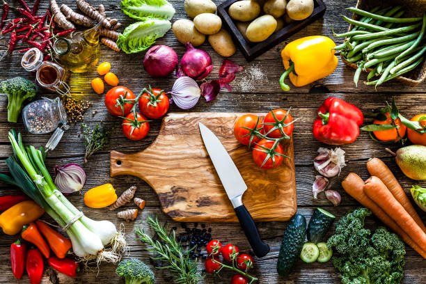 Fresh vegetables ready for cooking shot on rustic wooden table