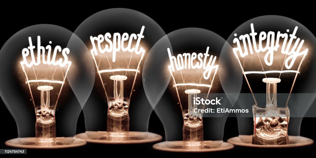 Light Bulbs Concept Photo of light bulbs with shining fibres in ETHICS, RESPECT, HONESTY and INTEGRITY shape isolated on black background Morality Stock Photo