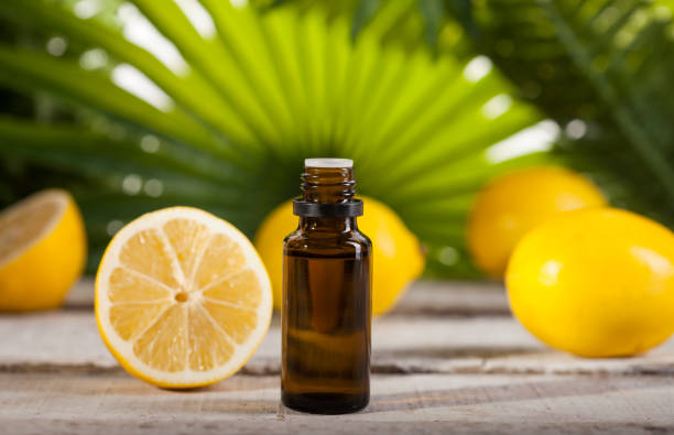 istock Lemon Essential Oil on green leaves background 1124754877