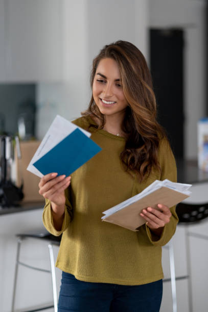 istock Beautiful woman at home checking the mail 1124755508