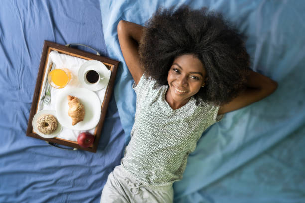 istock Smiling woman lying in bed 1124757561