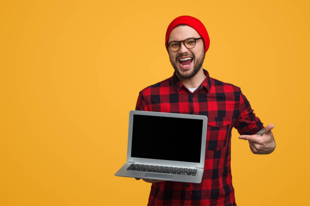 istock Excited hipster pointing at new laptop 1124757948