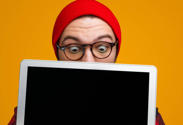 Excited hipster looking amazed with laptop